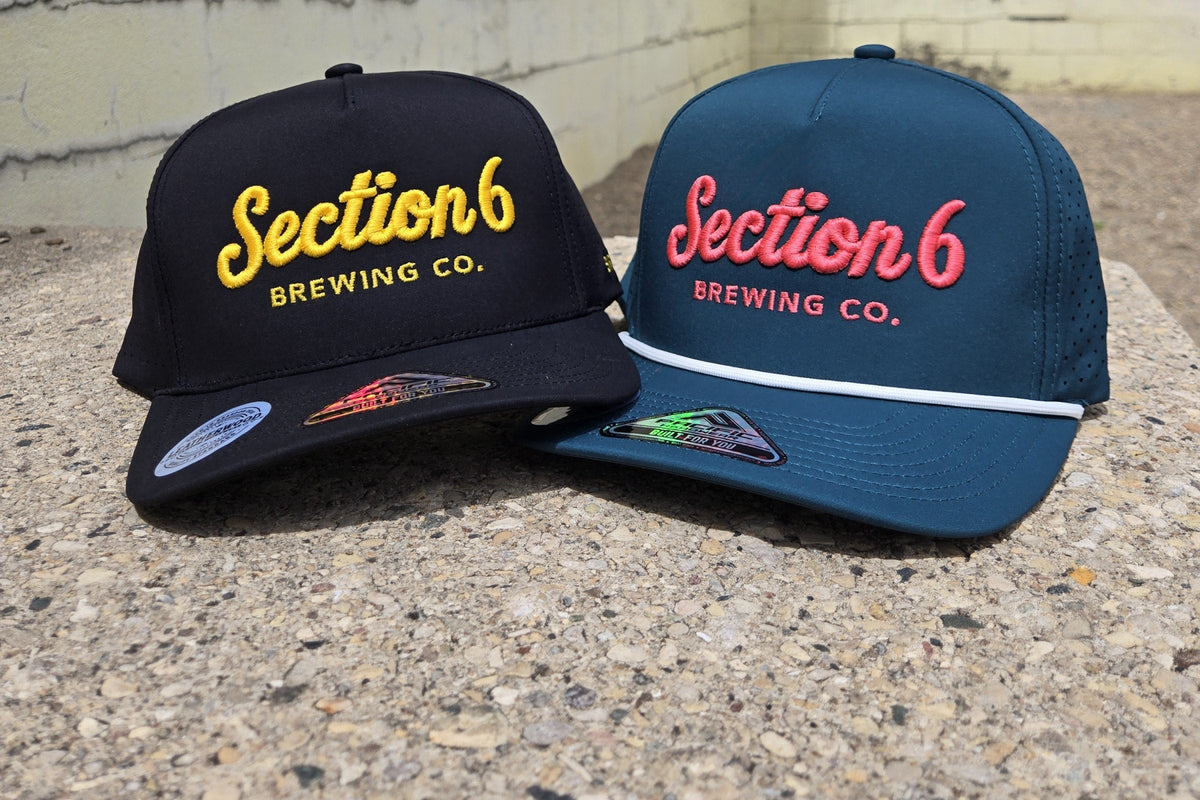 Black and teal trucker caps with Section 6 Brewing logos embroidered by Leatherwood